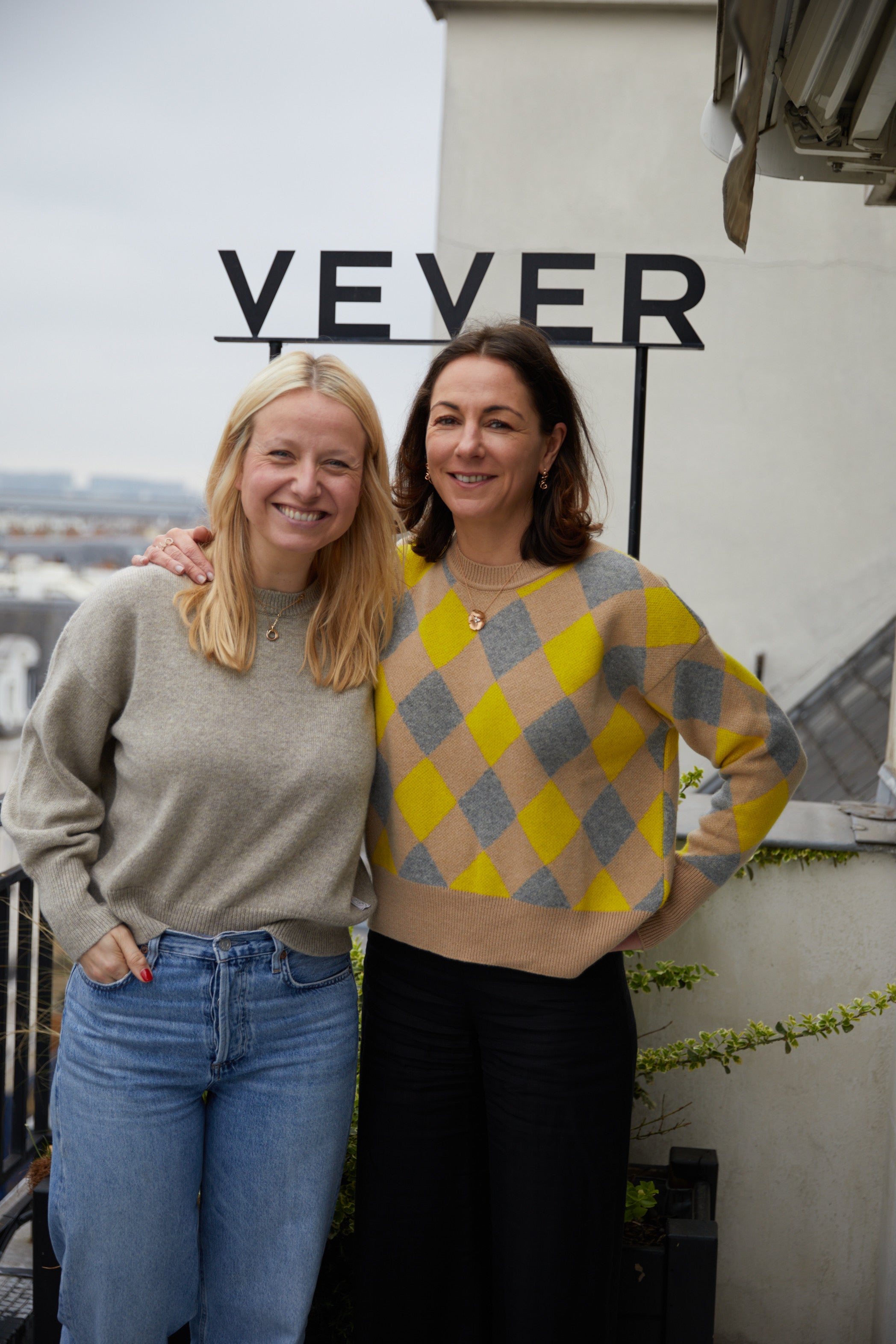 Camille Vever wearing the Sarah cashmere sweater in dark blue by Linnea Lund on the rooftop of the Vever jewelry maison in Paris.